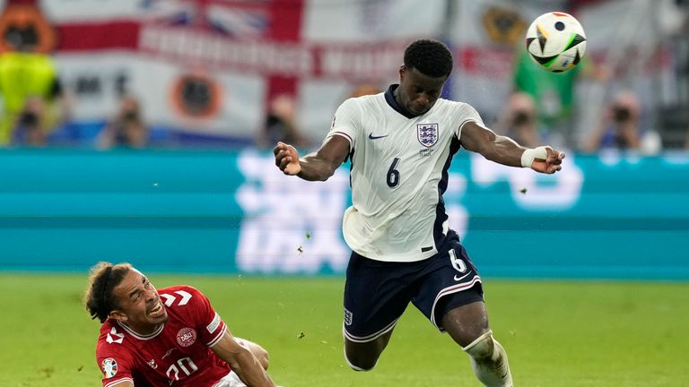 Denmark's Yussuf Poulsen, left, watches England's Marc Guehi during a Group C match between Denmark and England at the Euro 2024 soccer tournament in Frankfurt, Germany, Thursday, June 20, 2024. (AP Photo/Michael Probst)