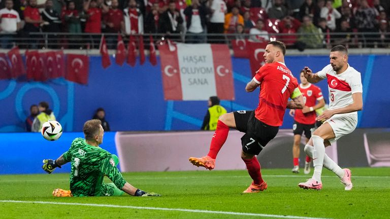 Austria's Marko Arnautovic, center, shoots against Turkey's goalkeeper Mert Gunok, left, during a round of sixteen match between Austria and Turkey at the Euro 2024 soccer tournament in Leipzig, Germany, Tuesday, July 2, 2024. (AP Photo/Martin Meissner)