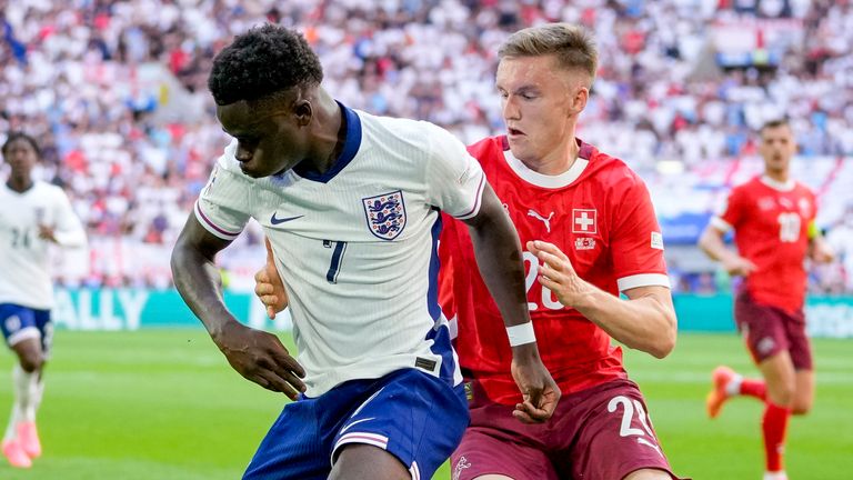 Bukayo Saka holds off Michel Aebischer 