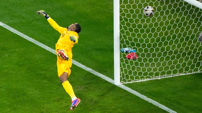 France goalkeeper Mike Maignan fails to stop Spain's first goal scored by Spain's Lamine Yamal during a semifinal match between Spain and France at the Euro 2024 soccer tournament in Munich, Germany, Tuesday, July 9, 2024. (AP Photo/Ebrahim Noroozi)