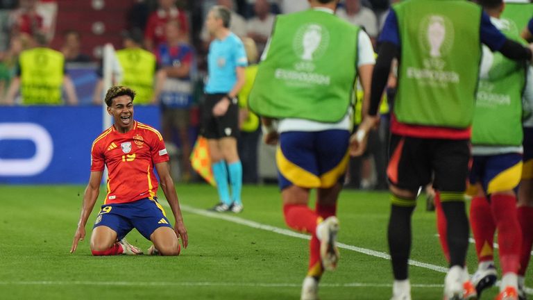 Yamal knee-slides in front of the Spain dugout