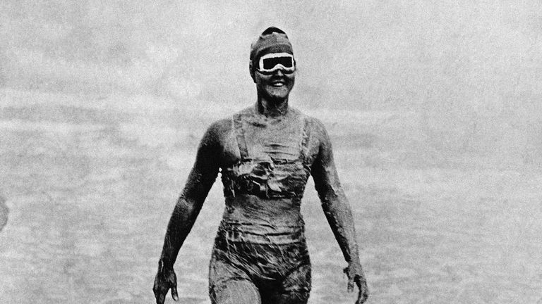 Gertrude Ederle enters the water with body greased and wearing goggles for the start of her record-breaking swim across the English Channel