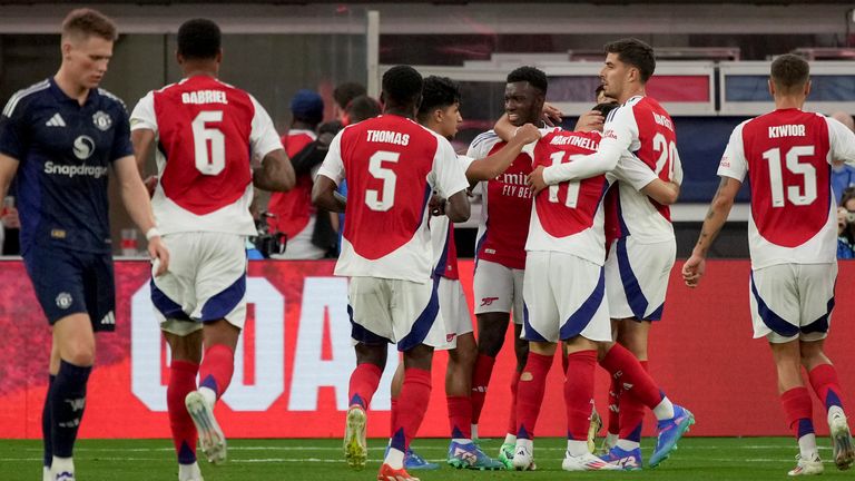 Arsenal players celebrate their equalising goal