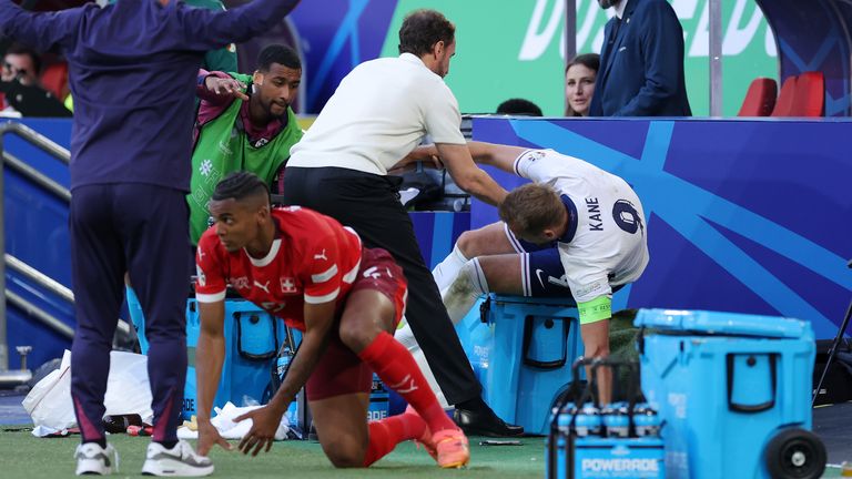 Gareth Southgate attempts to prevent Harry Kane falling into the England dugout