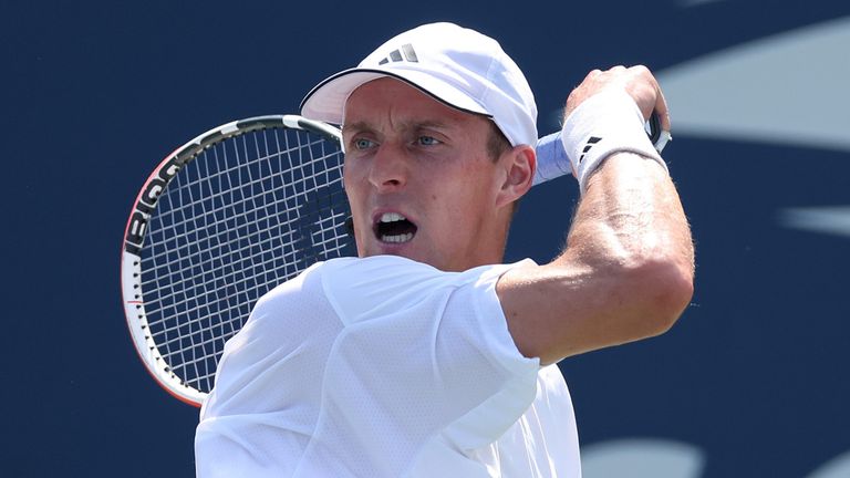 Jan Choinski of Great Britain returns against Roberto Carballes Baena of Spain during their Men's Singles First Round match on Day One of the 2024 US Open 