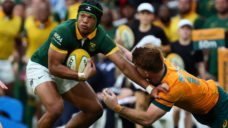 South Africa's Kurt-Lee Arendse.left, fends off a tackle from Australia's Andrew Kellaway during their rugby union test match in Brisbane, Saturday, Aug. 10, 2024. (AP Photo/Tertius Pickard)