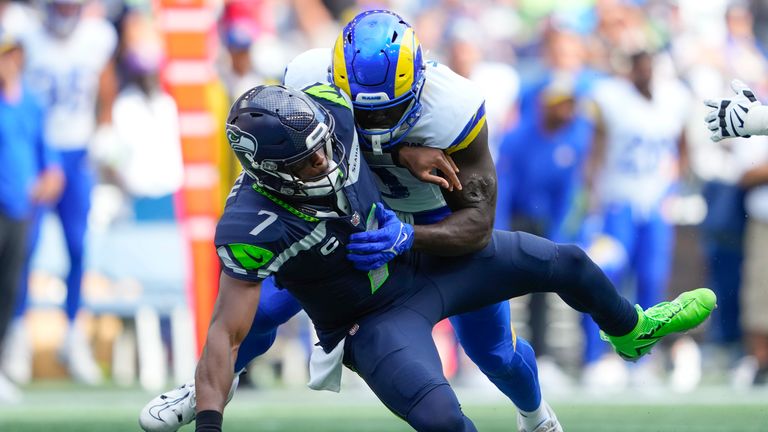 Seattle Seahawks quarterback Geno Smith (7) is sacked by Los Angeles Rams linebacker Byron Young (0) during the second half of an NFL football game, Sunday, Sept. 10, 2023, in Seattle. (AP Photo/Lindsey Wasson)