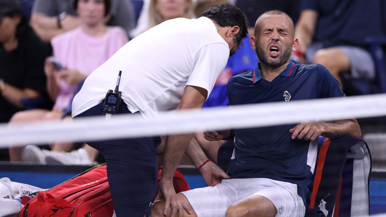 Dan Evans of Great Britain reacts as he is treated by a trainer between games against Alex de Minaur of Australia during their Men's Singles Third Round match on Day Six of the 2024 US Open at USTA Billie Jean King National Tennis Center on August 31, 2024 in the Flushing neighborhood of the Queens borough of New York City. (Photo by Luke Hales/Getty Images)